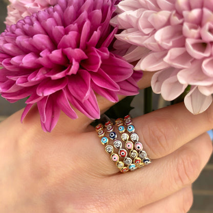 Alexandra Wearing the colorful evil eye eternity band rings in silver and gold