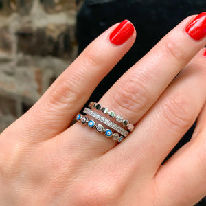 Thin Turquoise Evil Eye Eternity band stacked with two silver eternity bands from Alexandra Marks Jewelry