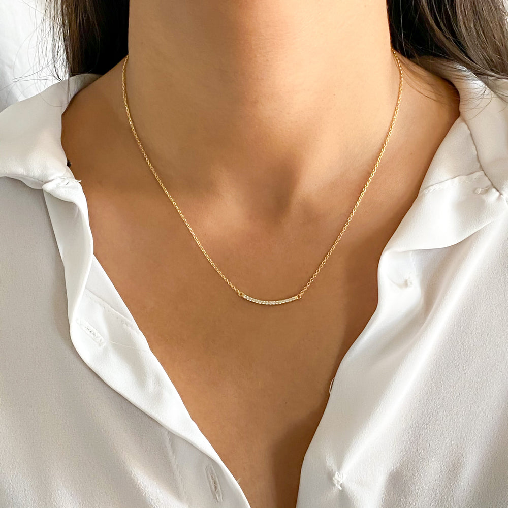 Wearing the gold curved bar necklace from Alexandra Marks Jewelry
