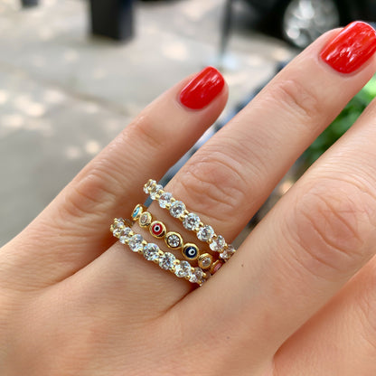 Stacking the multi-colored gold evil eye eternity band ring from Alexandra Marks Jewelry