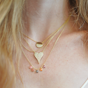 Layering the colorful evil eye charm necklace in gold from Alexandra Marks Jewelry