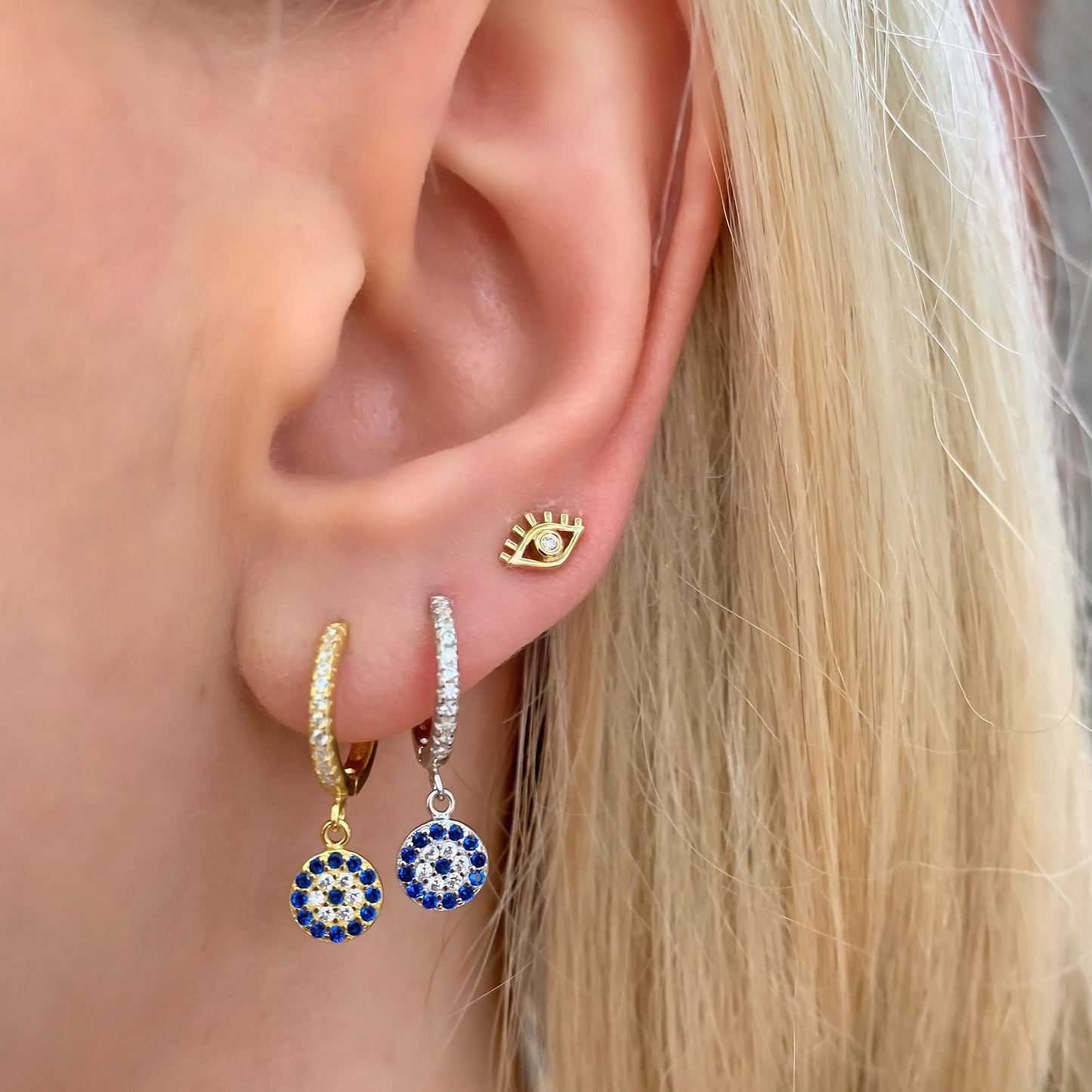 Wearing the gold and silver evil eye charm earrings from Alexandra Marks Jewelry