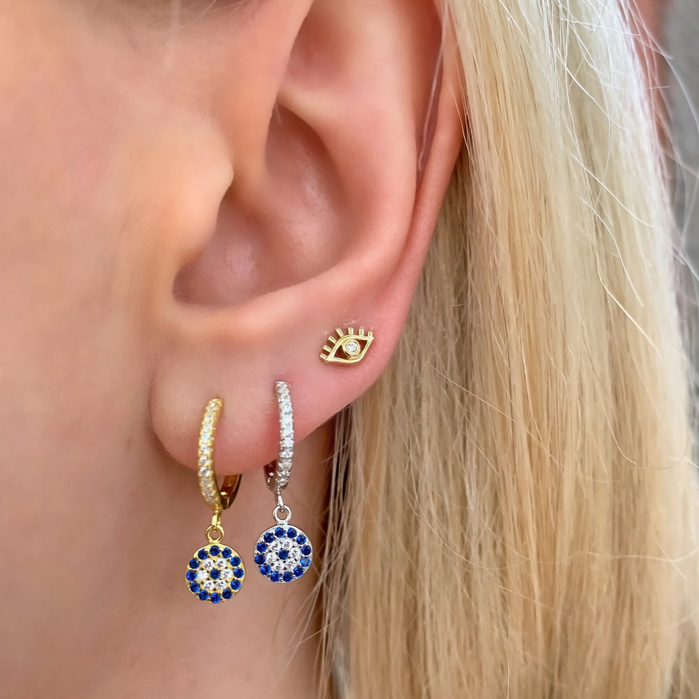 Wearing the gold and silver evil eye charm earrings from Alexandra Marks Jewelry