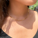 Wearing the gold oval thin paperclip choker necklace from alexandra marks jewelry